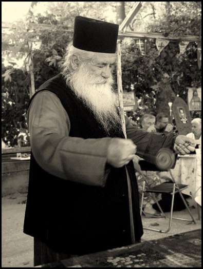 Father Polikarpos play at toy.
