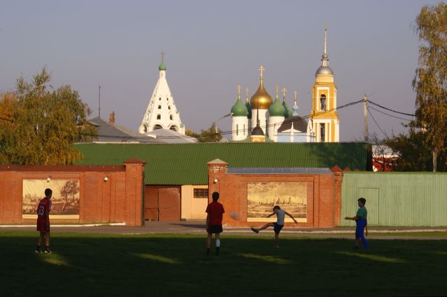 Young boys playing foot in the kremlin near Novo-Golutvin Monastery