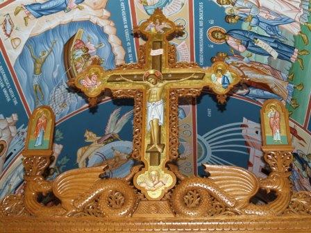 The cross spliting the dragons of sin and pride
