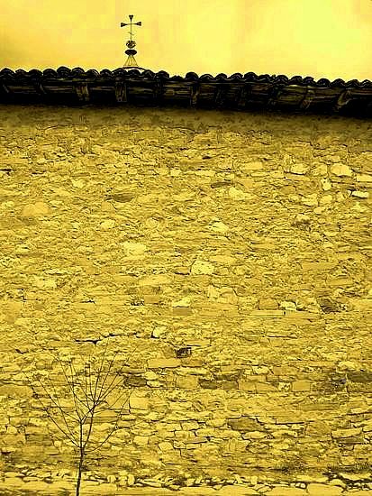 a cross behind the wall