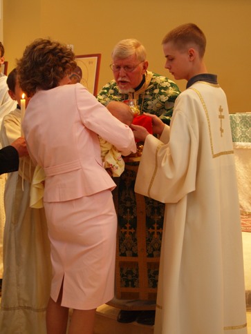 Sara the first to be baptized in the New St Luke Church and First to take Communion