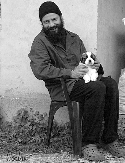 The young monk and the young caucasian dog