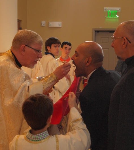 The Newly Chrismated, takes his first communion