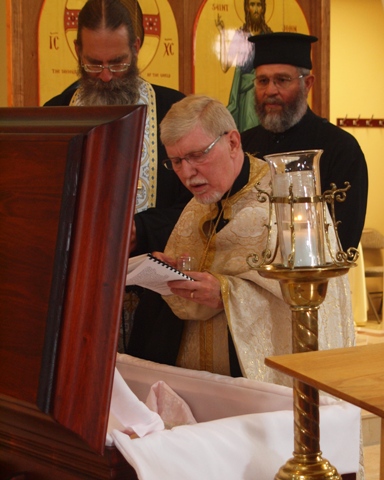 Fr David gives the final blessing and final kiss to his beloved mother