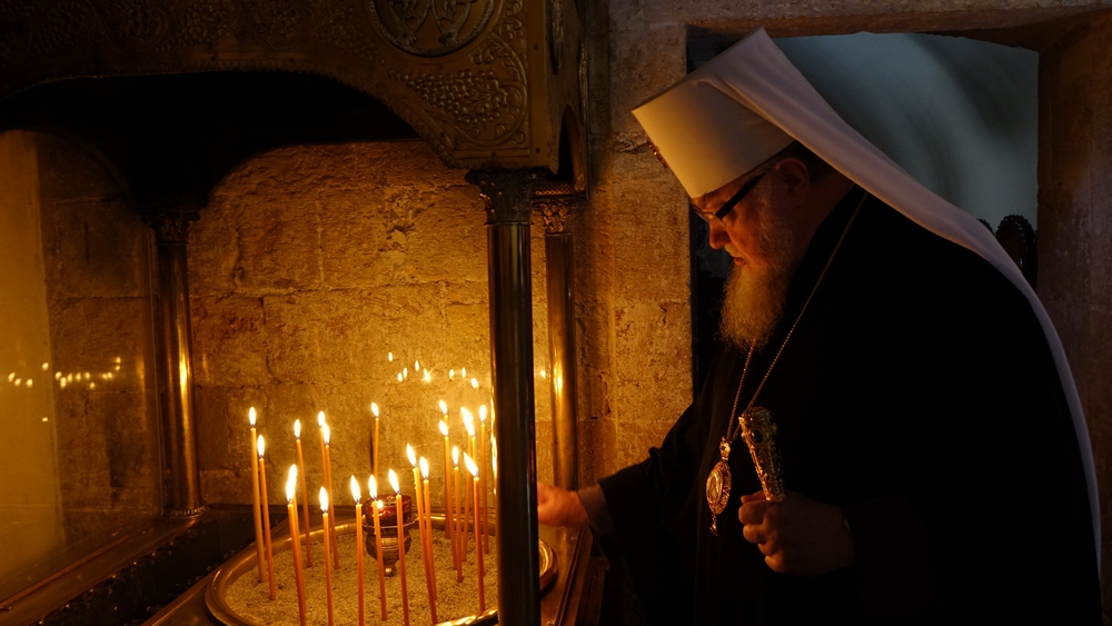 Metropolitan Sawa lights the candle in the church of Mother of God "Gonia" in Kolymbari