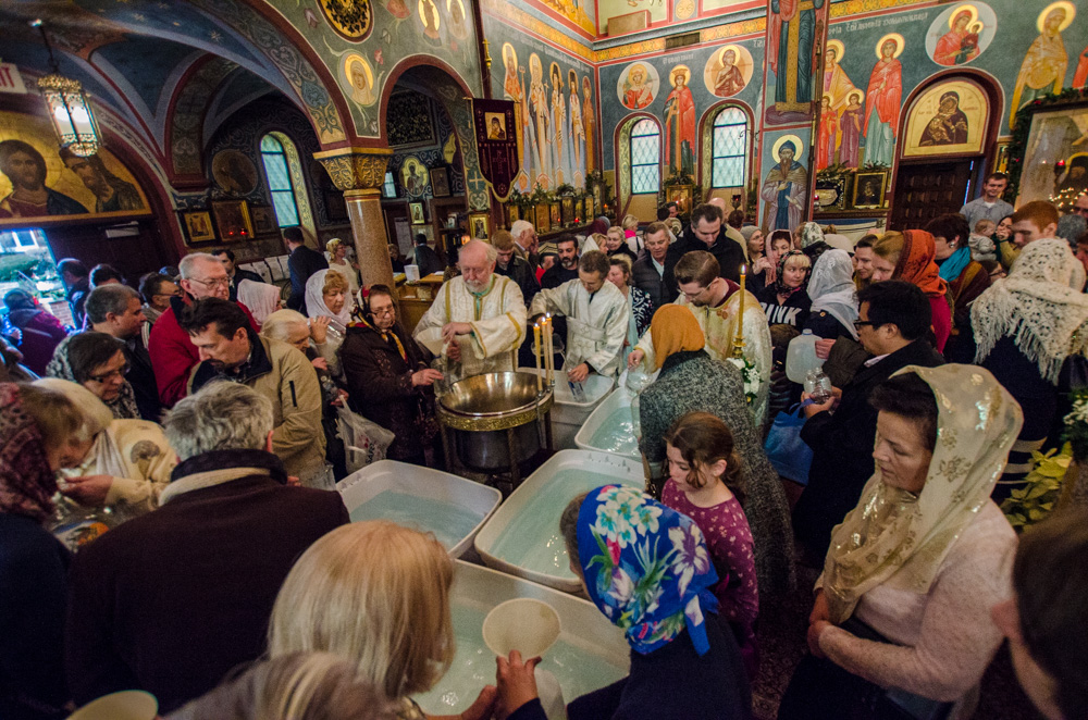 Faithful take Holy Water for use in their homes
