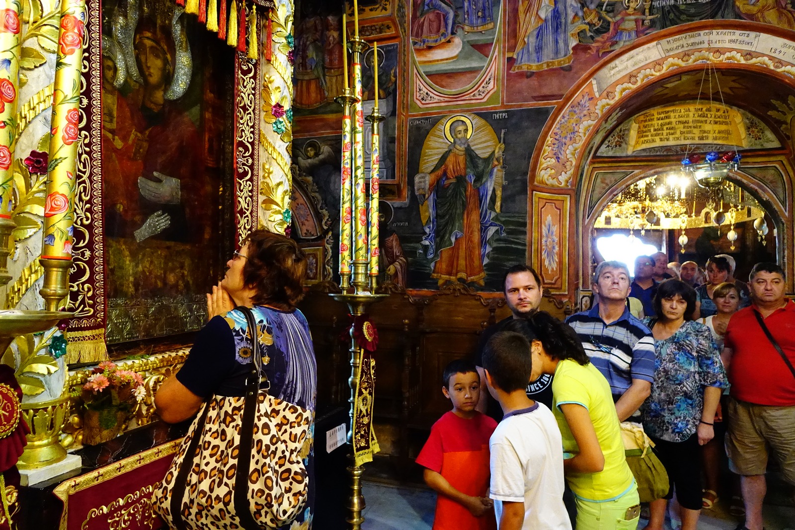 People praying in front of miraculous icon of the Mother of God in Trojanski Monastery