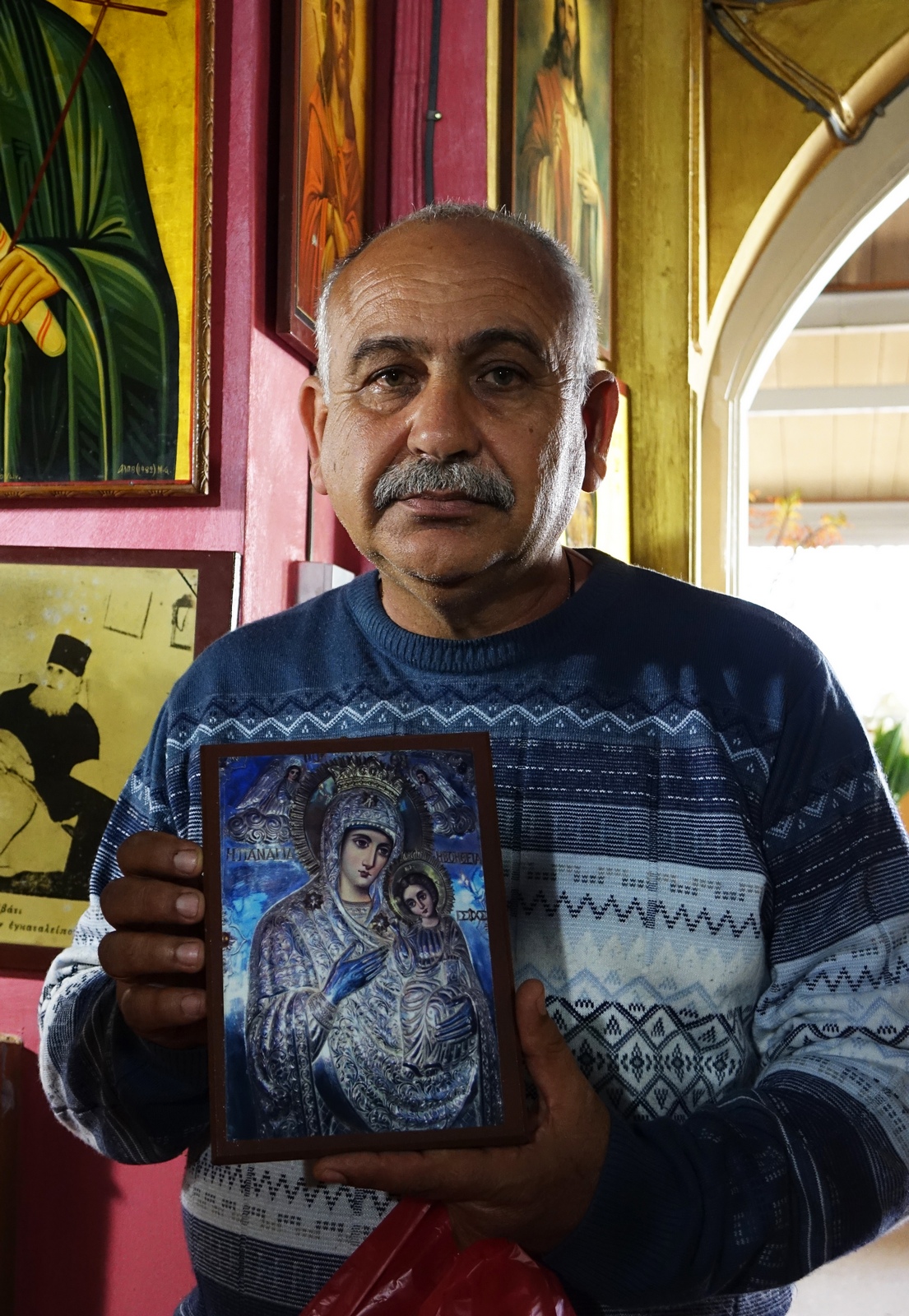 A guardian of St. Kandeas Convent with the Mother of God icon