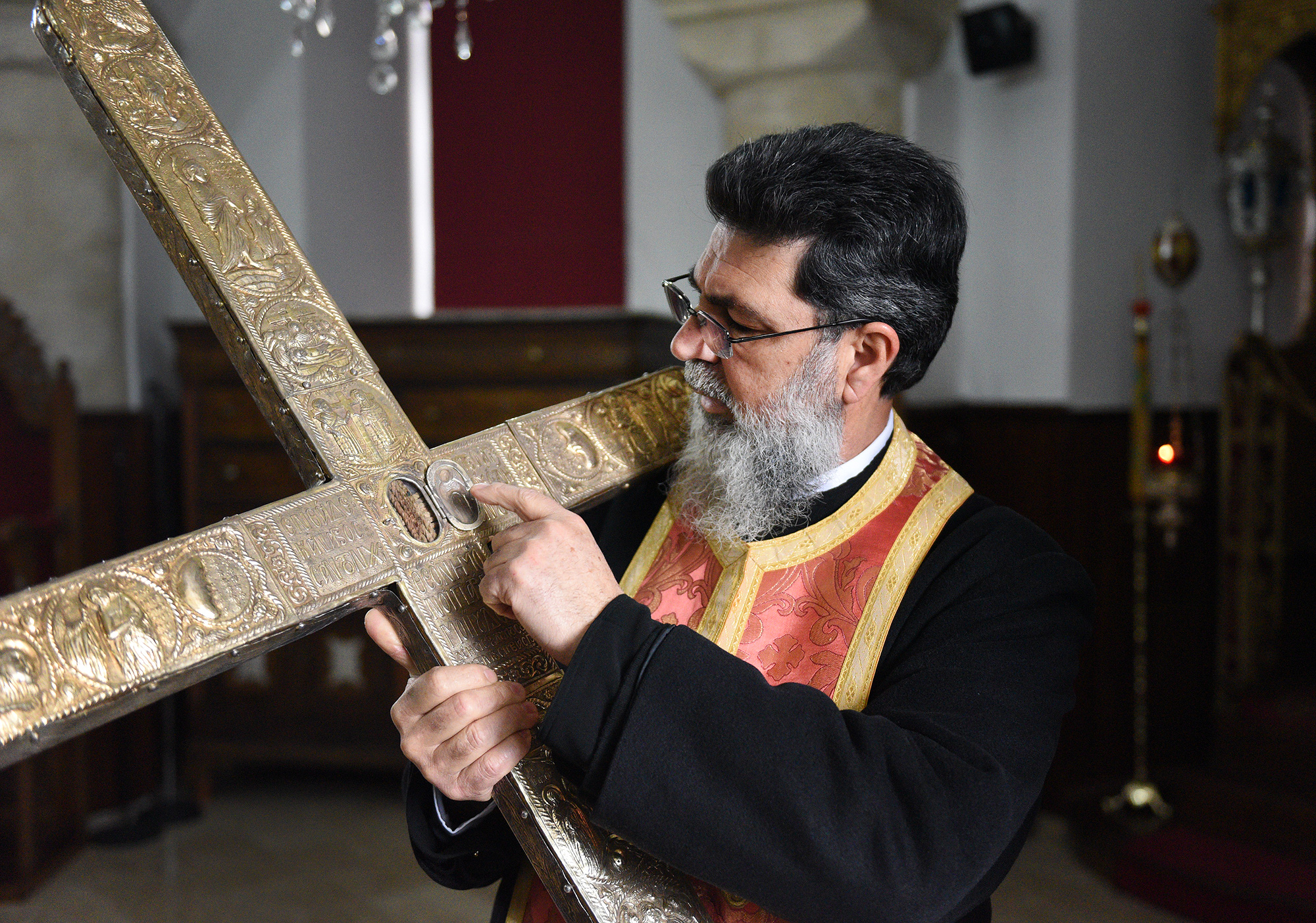 Fr Neophytos from Omodos holding piece of Holy Cross and rope