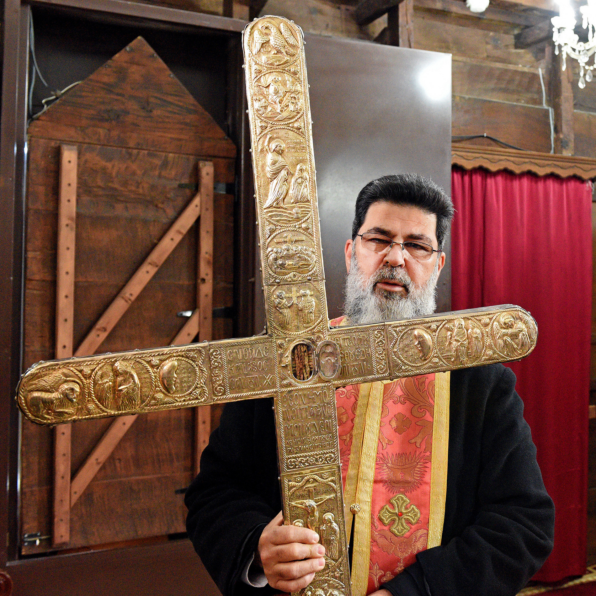 Fr Neophytos from Omodos holding piece of Holy Cross and rope