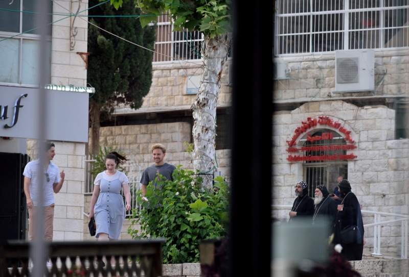 Coptic monks and tourists in front of the Eastern Orthodox centre in Nazareth